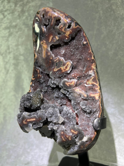 Amethyst And Calcite Geode Specimen. World Class Uruguayan Specimen. Very Rare Black, Red, And Orange Colors. Custom Made Steel Stand