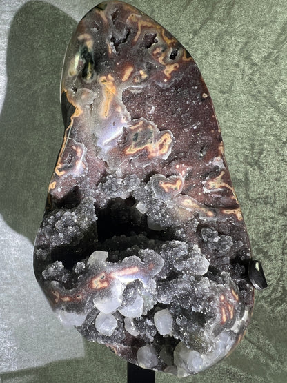 Amethyst And Calcite Geode Specimen. World Class Uruguayan Specimen. Very Rare Black, Red, And Orange Colors. Custom Made Steel Stand