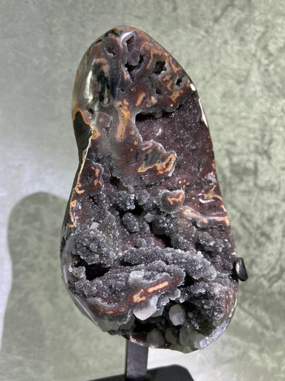 Amethyst And Calcite Geode Specimen. World Class Uruguayan Specimen. Very Rare Black, Red, And Orange Colors. Custom Made Steel Stand