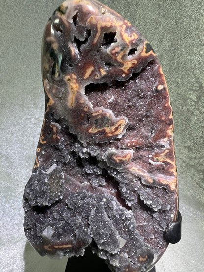 Amethyst And Calcite Geode Specimen. World Class Uruguayan Specimen. Very Rare Black, Red, And Orange Colors. Custom Made Steel Stand