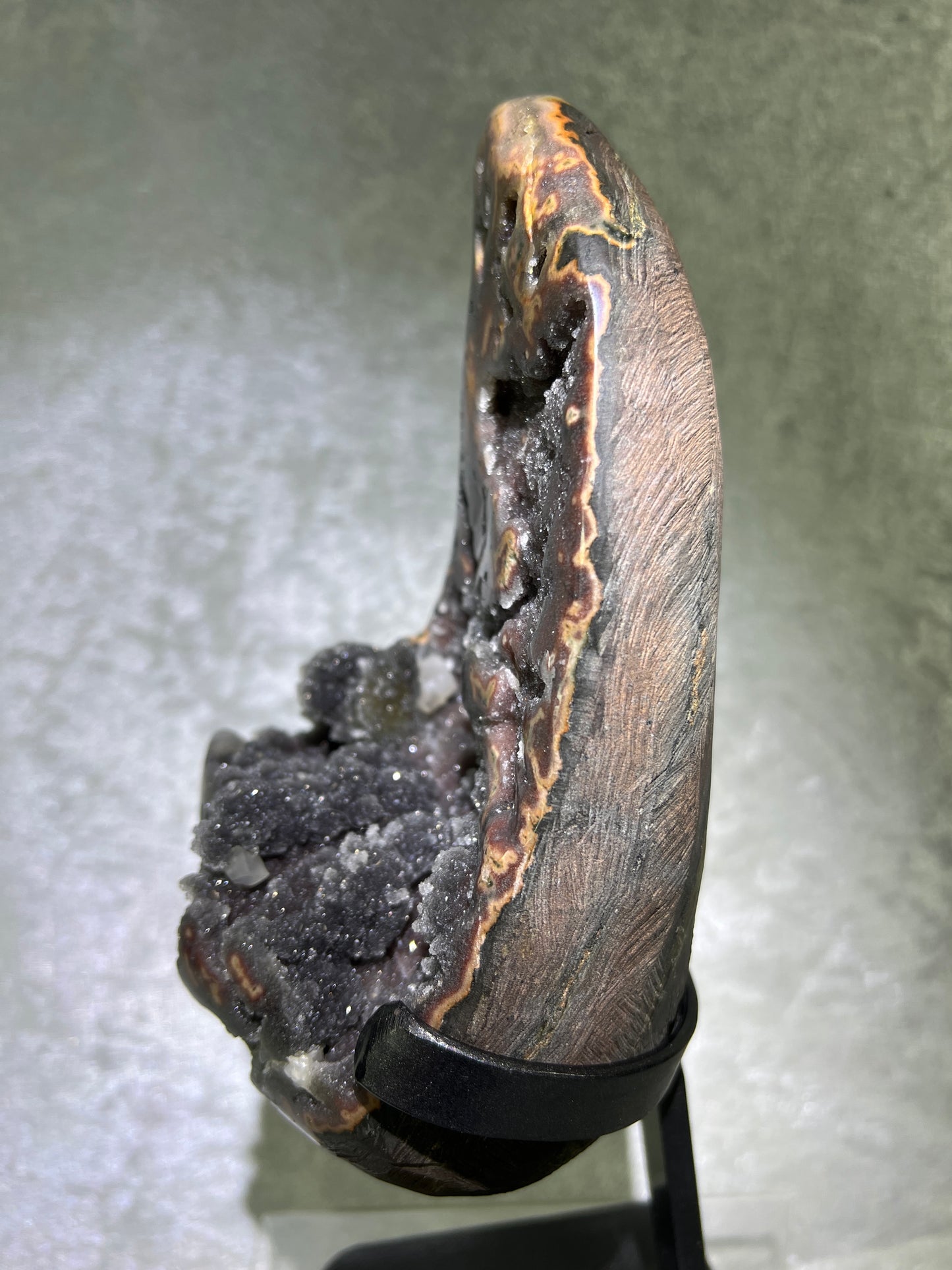 Amethyst And Calcite Geode Specimen. World Class Uruguayan Specimen. Very Rare Black, Red, And Orange Colors. Custom Made Steel Stand