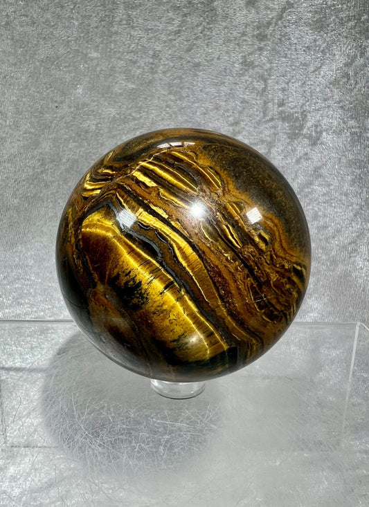 Amazing Tigers Eye And Hematite Crystal Sphere. 67mm. High Quality Rare Crystal. Gorgeous Patterns And Colors. Very Flashy Display Sphere.